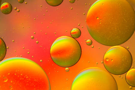 Psychedelic yellow and orange oil and water abstract backgroundの写真素材