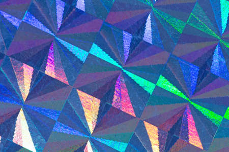 Psychedelic abstract formed by light reflecting off a textured metal surfaceの写真素材