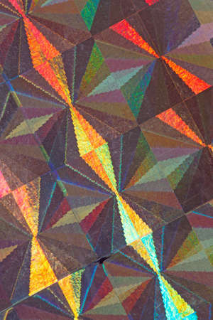 Psychedelic abstract formed by light reflecting off a textured metal surfaceの写真素材