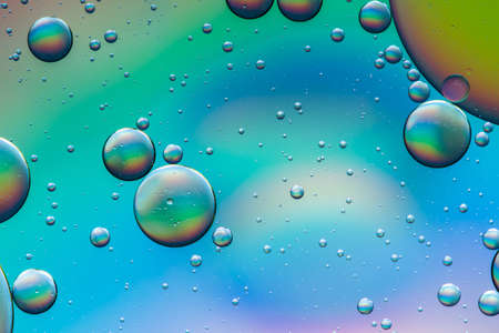 Psychedelic oil and water abstract background formed by oil droplets floating on waterの写真素材