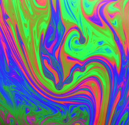 Psychedelic abstract formed by a soap bubble reflecting lightの写真素材