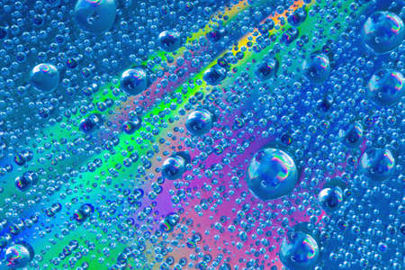 Colorful abstract formed by water droplets on the surface of a cdの写真素材