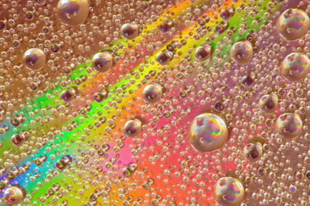 Colorful abstract formed by water droplets on the surface of a cdの写真素材