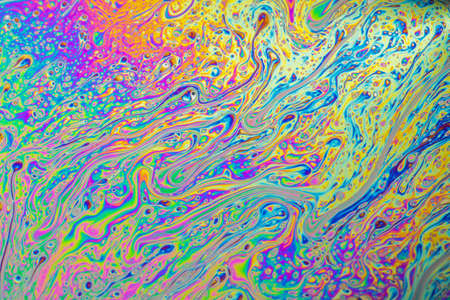 Psychedelic abstract formed by light interference on the surface of a soap bubbleの写真素材