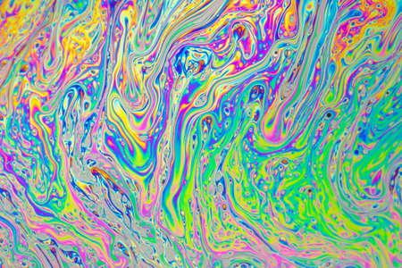 Psychedelic abstract formed by light interference on the surface of a soap bubbleの写真素材