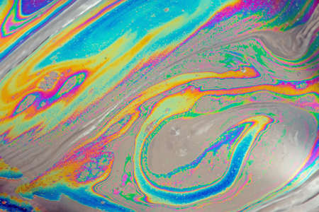 Psychedelic abstract formed by light interference on the surface of a soap bubbleの写真素材