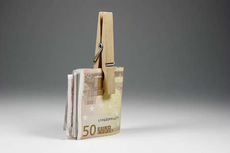 Euro banknotes held from a clamp の写真素材