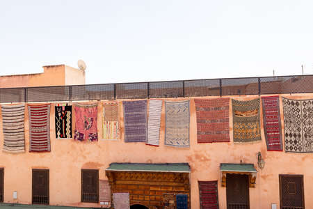 Moroccan rugs hang on the wall of a house in Marrakechの写真素材