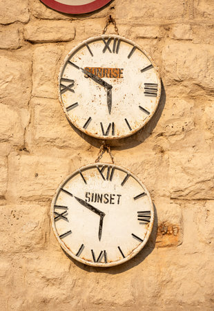 A clock that shows the time when the sun rises and when the sun sets in Namibia In the Etosha...