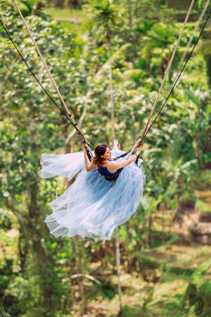 girl on a swing. Background of rice terraces. Ubud. Bali. Indonesiaの写真素材