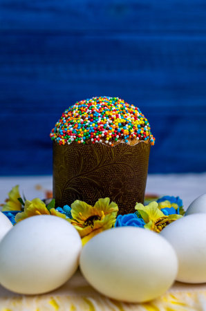 Easter. Traditional Ukrainian Easter cake with eggs on a blue background. Free copy space.