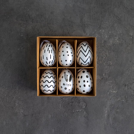 A box with colored eggs on a concrete background. Easter card, background.の写真素材