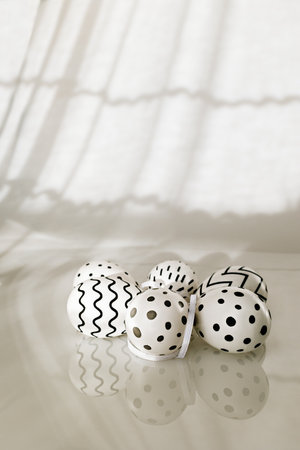 Easter eggs with a black and white pattern on a white backgroundの写真素材