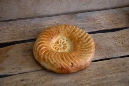 Uzbek bread on a wooden background.