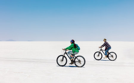 Tourists ride bicycles on the Salar de Uyuni salt lake, Bolivia