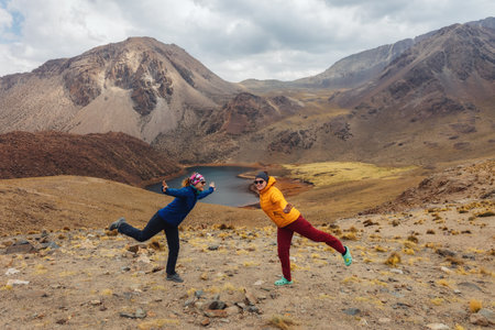 Two cheerful girls on the background of mountains and lagoons in Bolivia. Uyuni .Tomave. Potosi.の写真素材