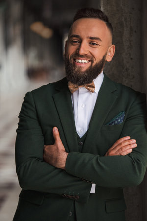Portrait of a successful smiling bearded man in a suitの写真素材