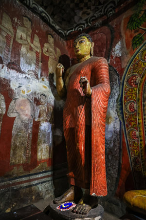 Buddha statue and fresco in the Buddhist cave temple in Dambulla, Sri Lankaの写真素材