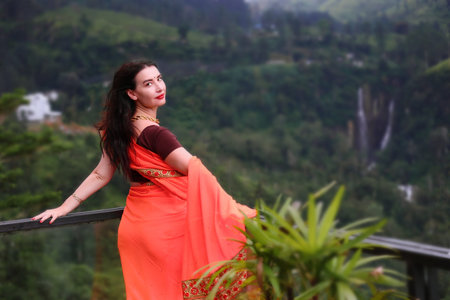Beautiful woman in a sari on a background of nature.