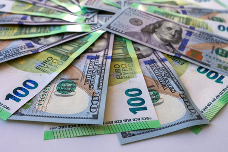 One hundred dollar and euro bills close-up