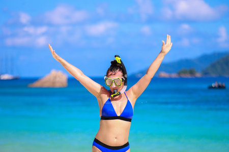 Woman in scuba mask on blue ocean background.の写真素材