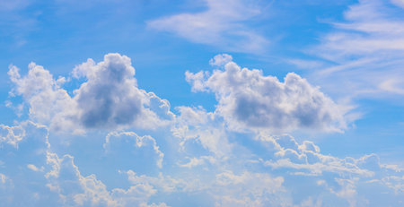 Vast blue sky decorated with fluffy cumulus clouds. sky backgroundの写真素材