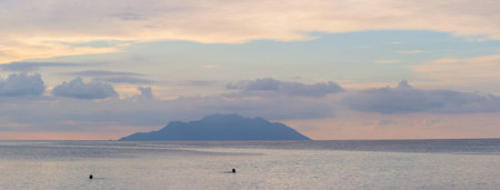 Serene Ocean View with Distant Island Silhouette at Twilightの写真素材