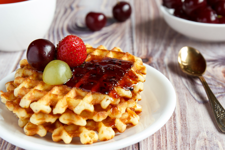 Tasty and healthy breakfast: waffles with fruit jam.の写真素材