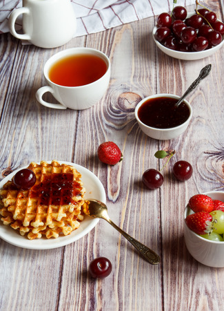 Tasty and healthy breakfast: waffles with fruit jam.の写真素材