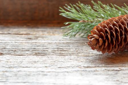 Pine cones and branches on wooden background Christmas backgroundの写真素材