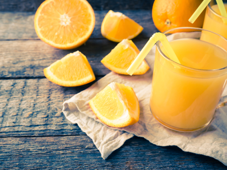 Fresh orange juice on wooden background, rustic style.の写真素材