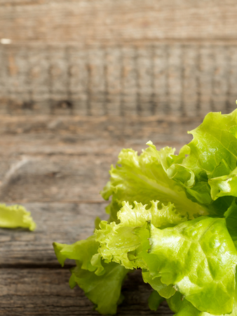 Green salad leaves on wooden rustic background. Copy space selective focus.の写真素材