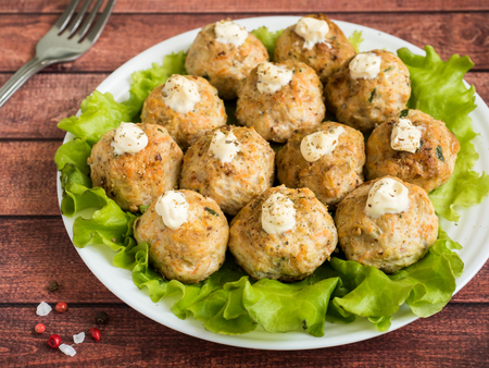 Delicious meatballs with parsley, lettuce and tomato closeup on a plate on the table. horizontal.の写真素材