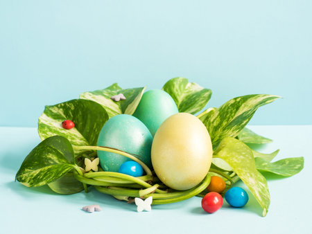 Easter eggs in nest from green leaves on a blue background.