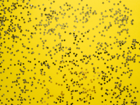 Yellow tape along the yellow background. Confetti star framingの写真素材