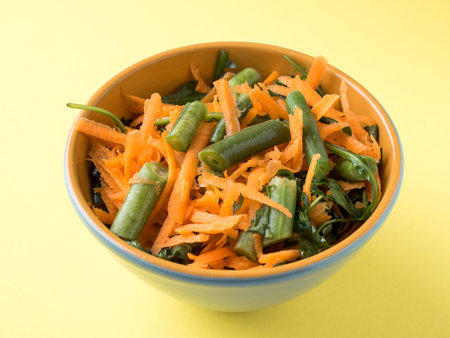 Healthy salad of grated carrots green bean arugulaの写真素材