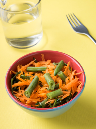 Healthy salad of grated carrots green bean arugulaの写真素材