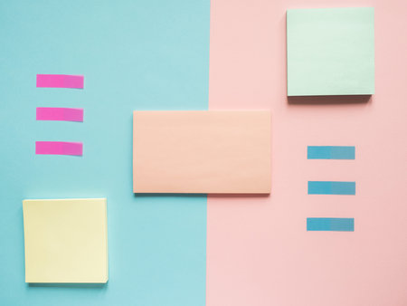 Business flat lay with copy space on a background divided in half pink and blue Notebooks to write...