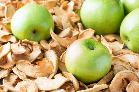 Background of sliced dried apples and ripe green apples.の写真素材