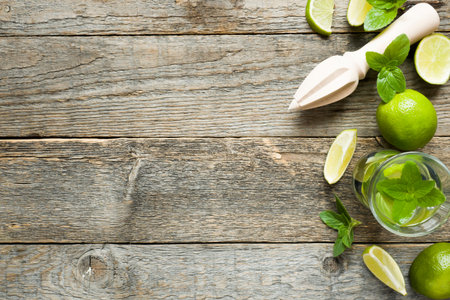 Fresh citrus lemonade in a glass of lime on a wooden background. Copy space for text.の写真素材