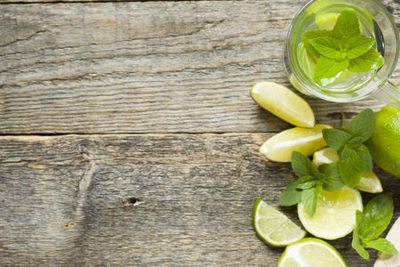Fresh citrus lemonade in a glass of lime on a wooden background. Copy space for text.の写真素材