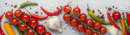 mixture of chili pepper cherry tomato on a branch garlic and other spices. copy space.の写真素材