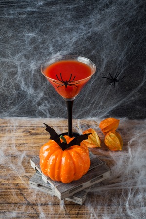Bloody Mary cocktail, pumpkin with bats and spiders for Halloween, selective focus.の写真素材