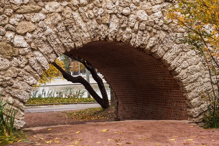 Arch of old gray stone texture, view of the city Park.の写真素材