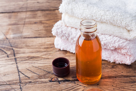 Terry towel and cosmetic oil for massageの写真素材