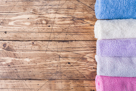 Spa and Wellness concept on wooden background. Stack of Terry towels. Copy spaceの写真素材