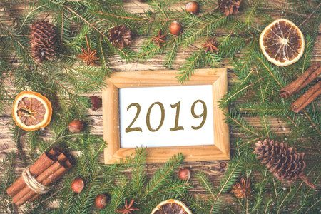 Creative layout of the branches of the Christmas tree inscription 2019. Flat position. The nature of...