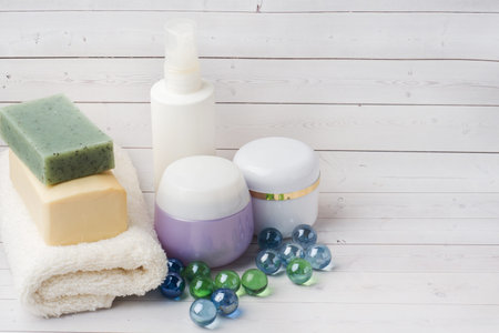 Towels cream soap and bath accessories Copy space
