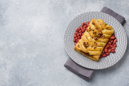 Puff pastry with peanuts and caramel filling for Breakfast copy space