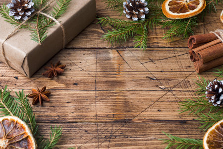 Christmas gift wrapped with decorations on a wooden table. Copy spaceの写真素材